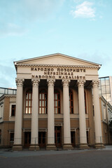 Obraz premium Close-up of the National Theatre in Subotica, Serbia showing its neoclassical columns and inscriptions in three languages.