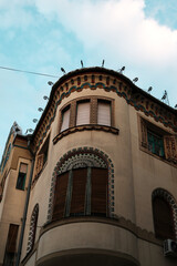 Decorative art nouveau corner building in Subotica, Serbia, with ornate windows and colorful trim details. Hungarian architecture in Serbia country.