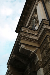 Close-up of ornate balcony with classical sculptures on a historic building in Subotica, Serbia.