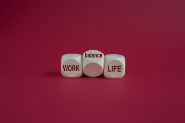 Work life balance message written on wooden cubes with red background. Conceptual work life balance...