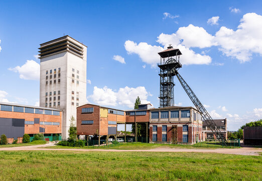 Loos-en-Gohelle, France - May 11, 2025: Extraction tower of the former pit no. 19 (left) and steel headframe of the former pit no. 11 (right) of the Compagnie des mines de Lens coal mining company.