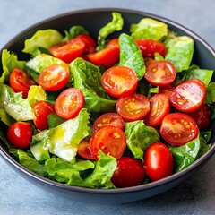Summer Salads crisp dressing Fresh salad featuring vibrant tomatoes and crisp greens in a black bowl.