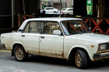 Old Rusty Soviet Car on Urban Street