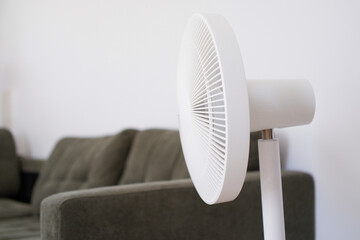 White electric fan in minimalist home interior – side view