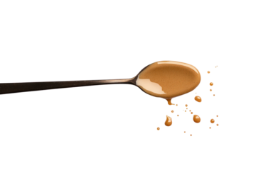 Creamy Delight: A close-up shot of a spoon brimming with creamy, smooth, delicious food substance, with playful drops scattered, it creates a visual feast for the senses.