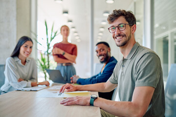 Business team collaborating on a project, analyzing data, and developing innovative strategies in a bright, modern office space