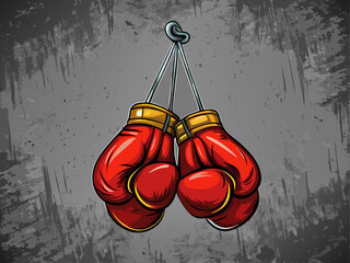 A pair of boxing gloves hanging from a hook, placed on textured gray wall background