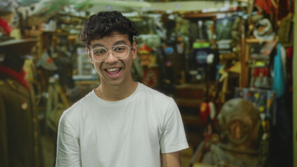 Man wearing glasses and white t shirt talking inside building hardware shop; product exploration...