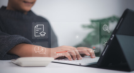 E-learning technology shown as young person types on laptop with virtual icons of education, documents, lightbulb, graduation cap, and question mark, symbolizing modern digital learning.