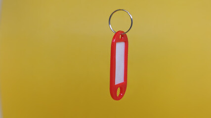 Red Key Tag, Yellow Backdrop.