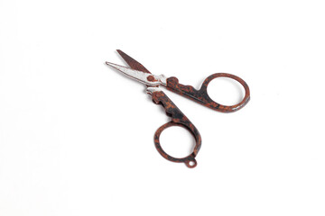 small rusty scissors full of dust isolated white background