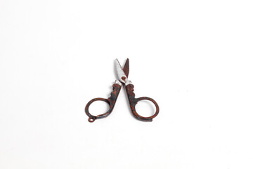 small rusty scissors full of dust isolated white background