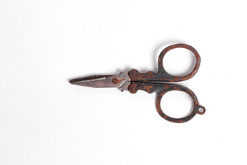 small rusty scissors full of dust isolated white background