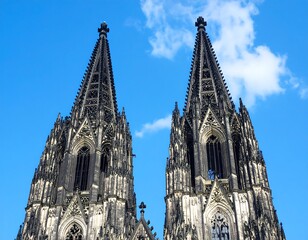 Gothic spires against a vibrant blue sky