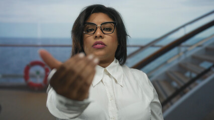 Woman gesturing invitation on luxurious cruise boat with ocean backdrop