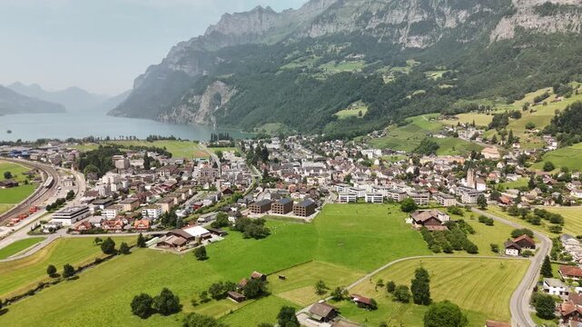 Scenic Aerial View of a Valley with Green Fields and Mountain Landscape in Switzerland near Flums, Berschis, and Walenstadt in the Canton of St. Gallen &ndash; Drone Footage
