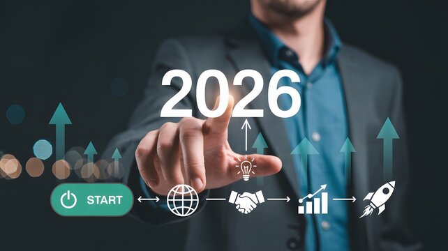 A man in a suit pointing to the year two thousand twenty six with business icons below it shown