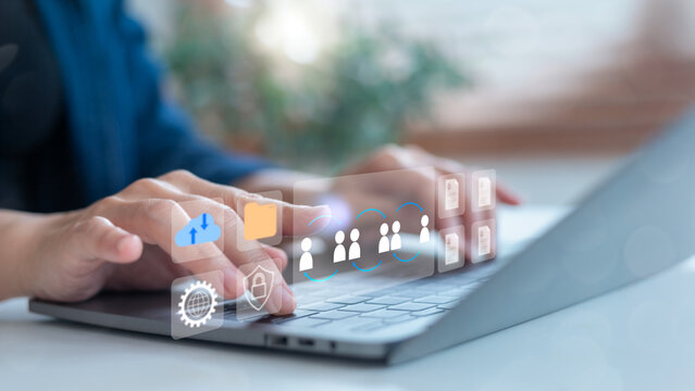 Hands typing on a laptop with cloud computing, file sharing, and team collaboration icons, representing digital communication and secure data exchange. - Powered by Adobe