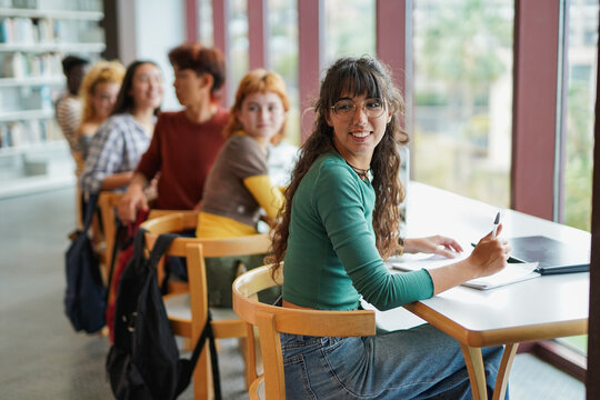 Happy young students learning together inside school classroom - Multiracial people, university and education concept