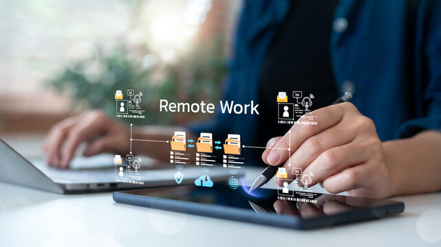 Close-up of remote working using laptop and tablet with file sharing icons and team connection, illustrating online collaboration and digital workflow.