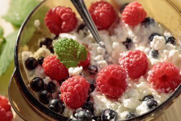 Cottage cheese with fresh raspberries and  blueberries.