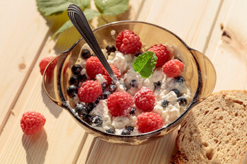 Cottage cheese with fresh raspberries and  blueberries.