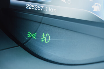 Green fog light indicators on a car dashboard