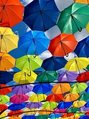 Colorful umbrella installation hanging above a pedestrian street in Bialystok, Poland. Urban art and playful public decoration.	