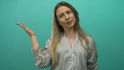 Middle age blonde woman making peace sign with hand in studio; victory confidence empowerment...