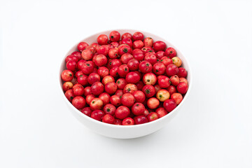 a bowl of red apples on a white surface