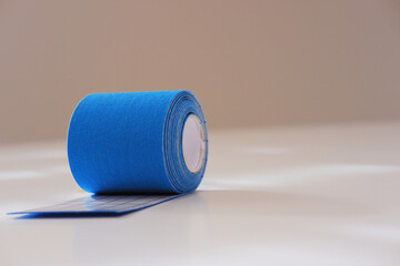 Blue kinesio tape roll partially unrolled