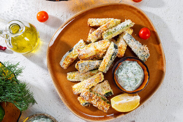 Healthy zucchini fries with yogurt and herbs sauce on the white background