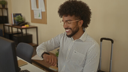 African american man in office checking watch, showcasing a professional workplace environment with desk and chair, conveying a modern indoor business setting.