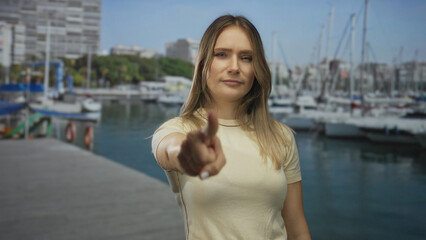 Woman gestures on a seaside boat dock with a determined expression, showcasing a dynamic and lively...