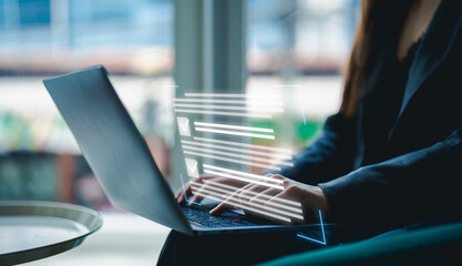 A person typing on a laptop with digital elements floating above, representing technology and productivity in a modern workspace.