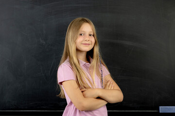 Portrait of a smiling schoolgirl blank chalkboard