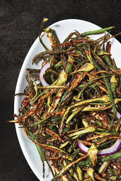 Okra-cooked-on-white-plate-dark-stone-background