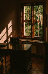 Warm light through old wooden windows, cozy interior with sunlight and architectural charm.