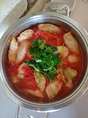 Top view of vegetable-stuffed cabbage rolls in metal pot, ukrainian delight