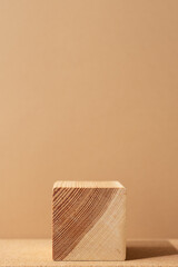 Wooden podium on a beige background. Abstract minimal scene of a geometrical form. Empty showcase, display case.