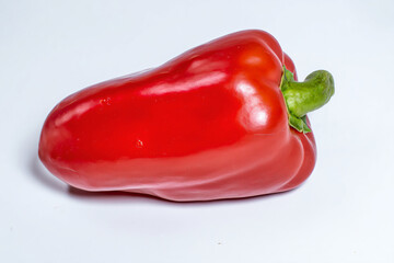 a red pepper on a white surface