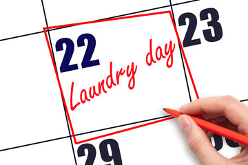 22nd day of the month.  Hand writing Laundry day reminder and drawing red frame on calendar with...
