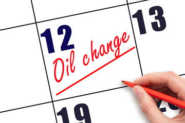 12th day of the month.  Hand writing Oil change reminder and drawing a line on calendar with red...