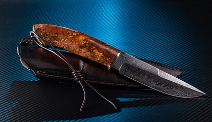 Damascus steel hunting knife with curly birch handle, leather lanyard and sheath.
