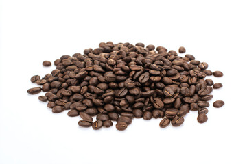 a pile of coffee beans on a white surface