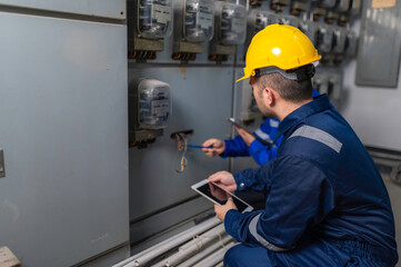 Electrical engineers and technicians work together to solve electrical system failures in...