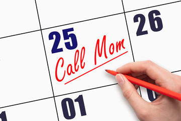 25th day of the month.  Hand writing Call Mom reminder and drawing a line on calendar with red pen...