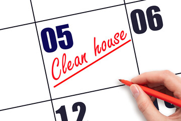 5th day of the month.  Hand writing Clean house reminder and drawing a line on calendar with red...