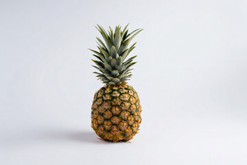 a pineapple sitting on a white surface