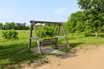Fototapeta premium A close view of the wood swinging bench on a sunny day.